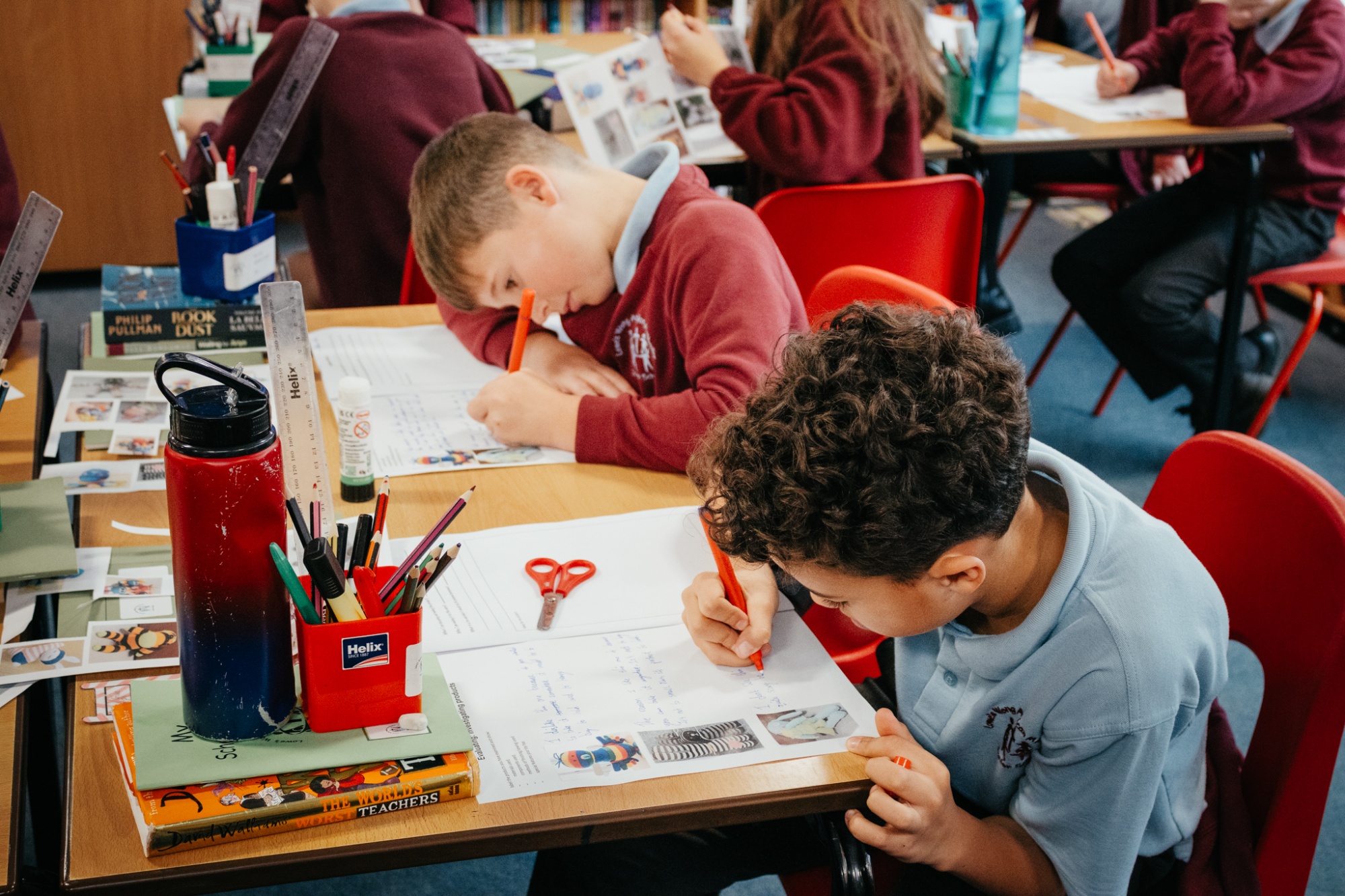 two students completing a worksheet in class